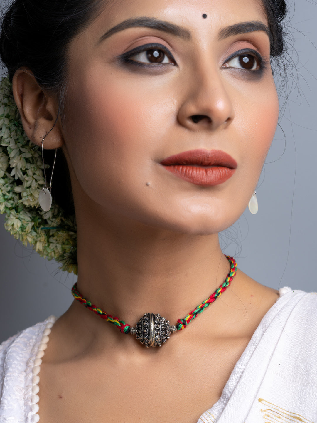 Handmade german silver choker necklace with colorful braided cord worn by woman