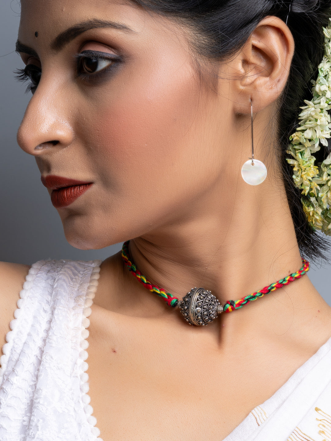 Handmade german silver choker necklace with intricate pendant on woman wearing white top