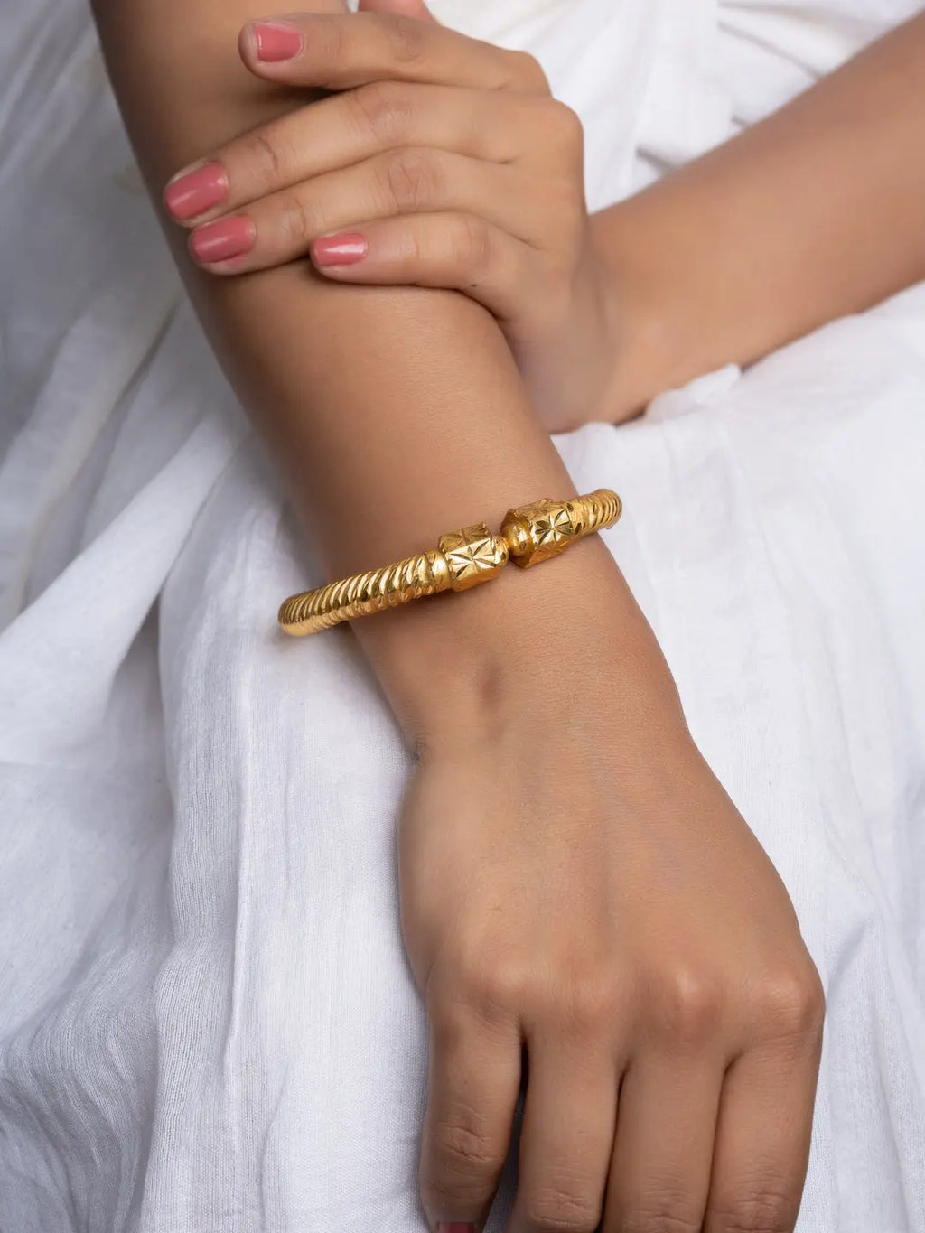 LOOK AND ADORN gold plate bangle twisted rope design with engraved end caps on model wrist