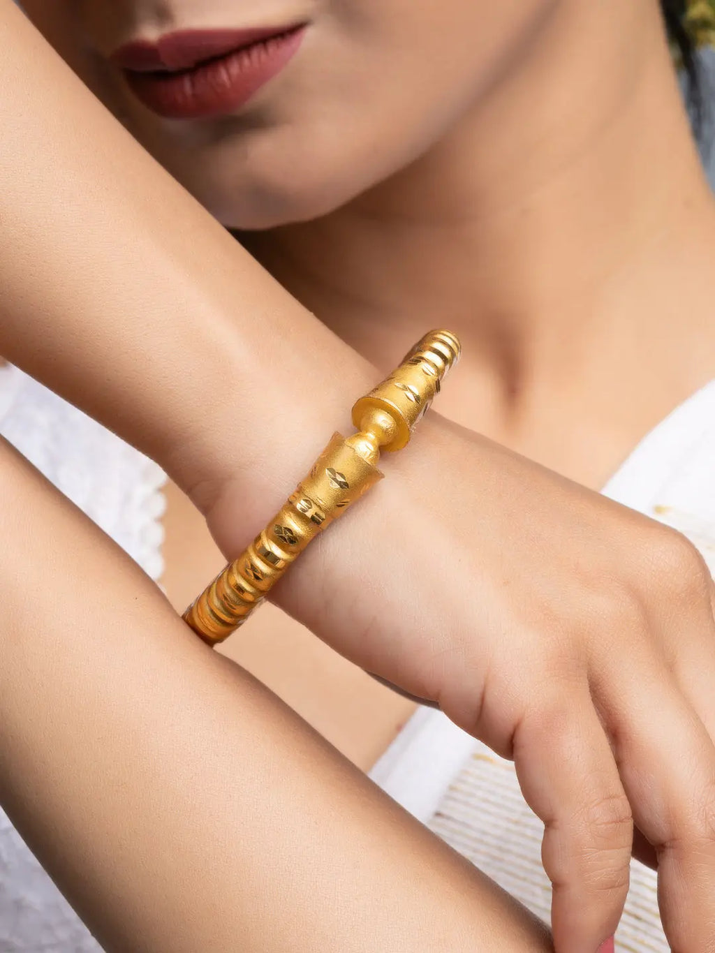 LOOK AND ADORN gold plated bangle on model wrist with textured beaded segments elegant everyday jewelry