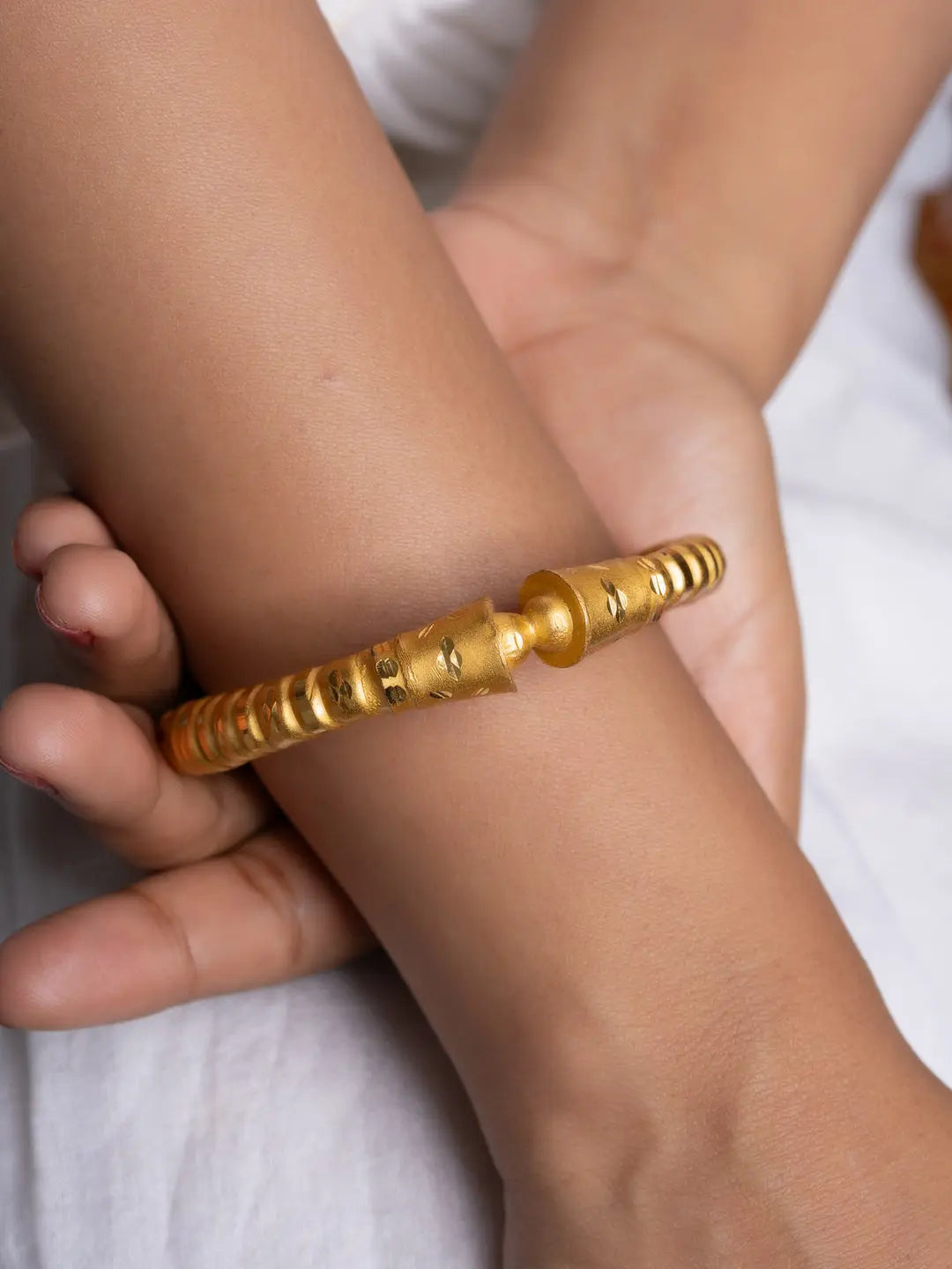 LOOK AND ADORN designed for you gold plated bangle on wrist with textured cylindrical bead design