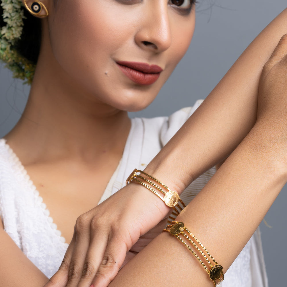 LOOK AND ADORN gold plated bangle set on model wearing white saree highlighting intricate chain link design