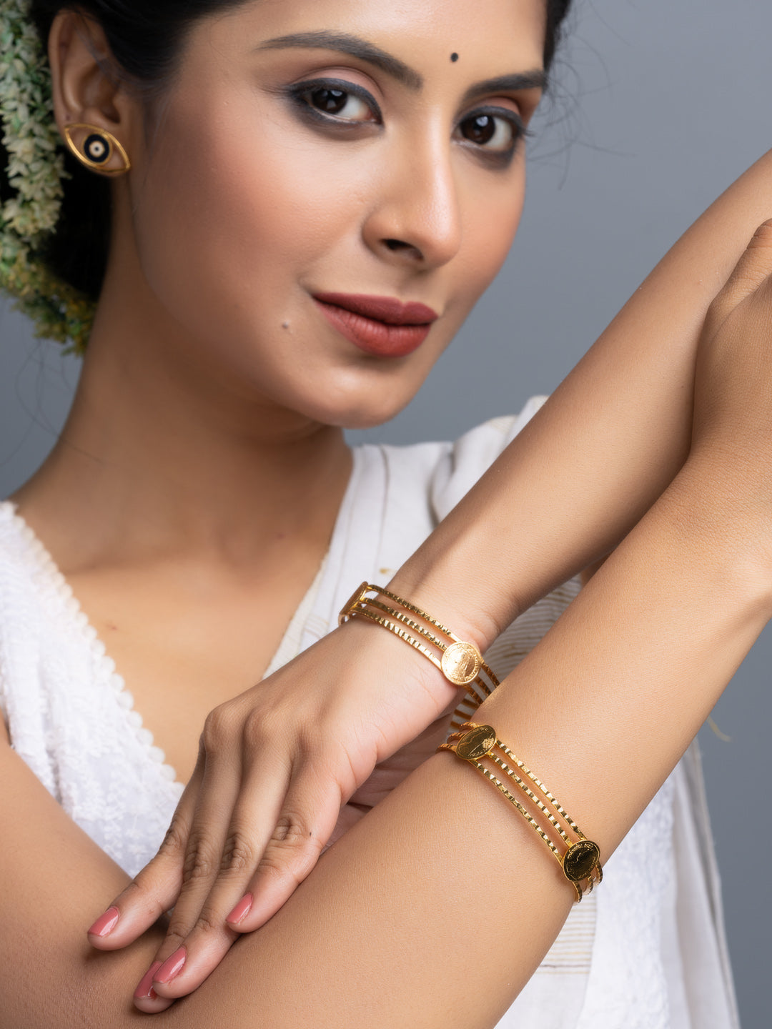 LOOK AND ADORN gold plated bangle set on model wearing white saree highlighting intricate chain link design