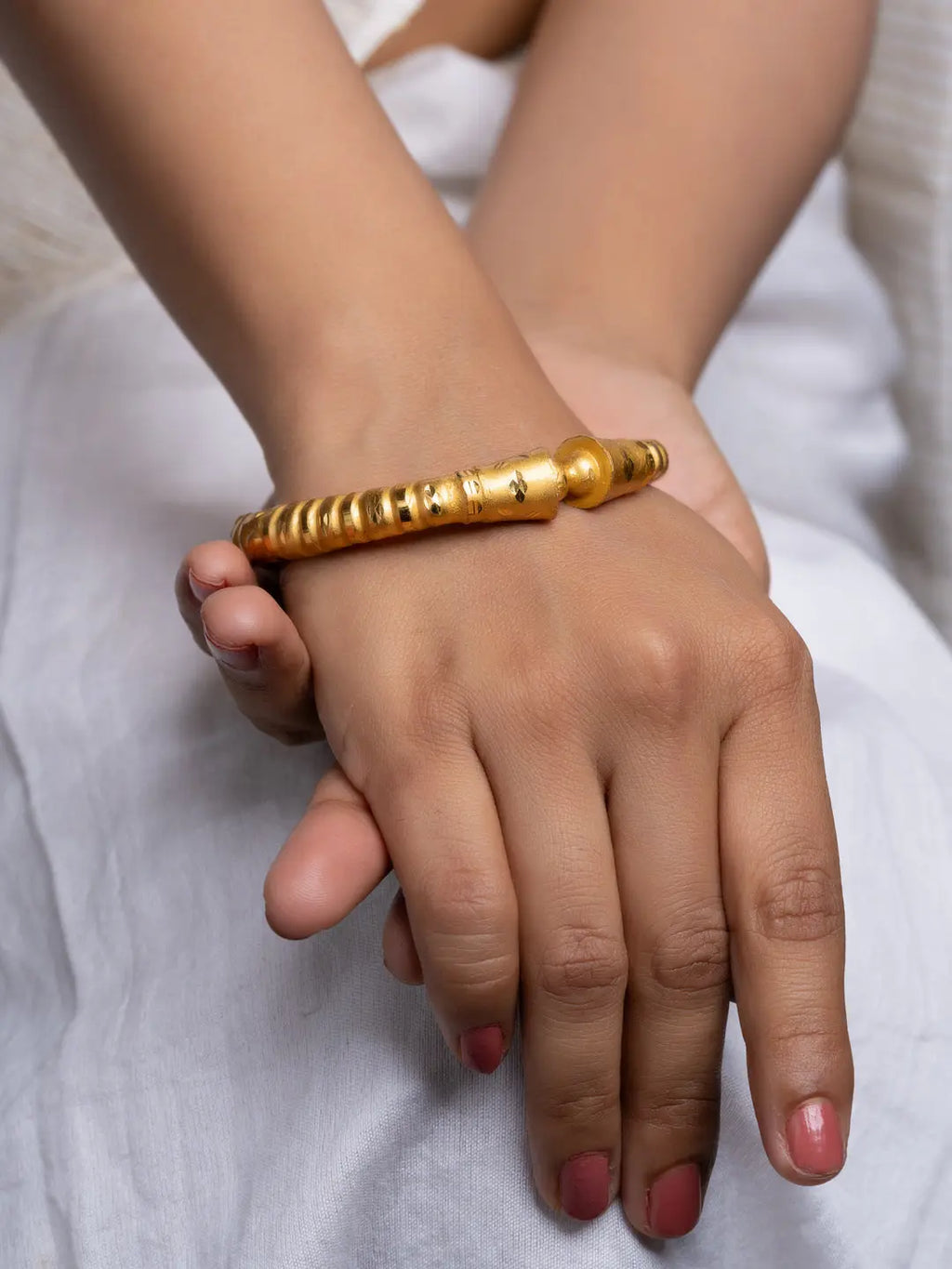LOOK AND ADORN gold plated bangle on a model wrist polished ribbed finish perfect for everyday wear