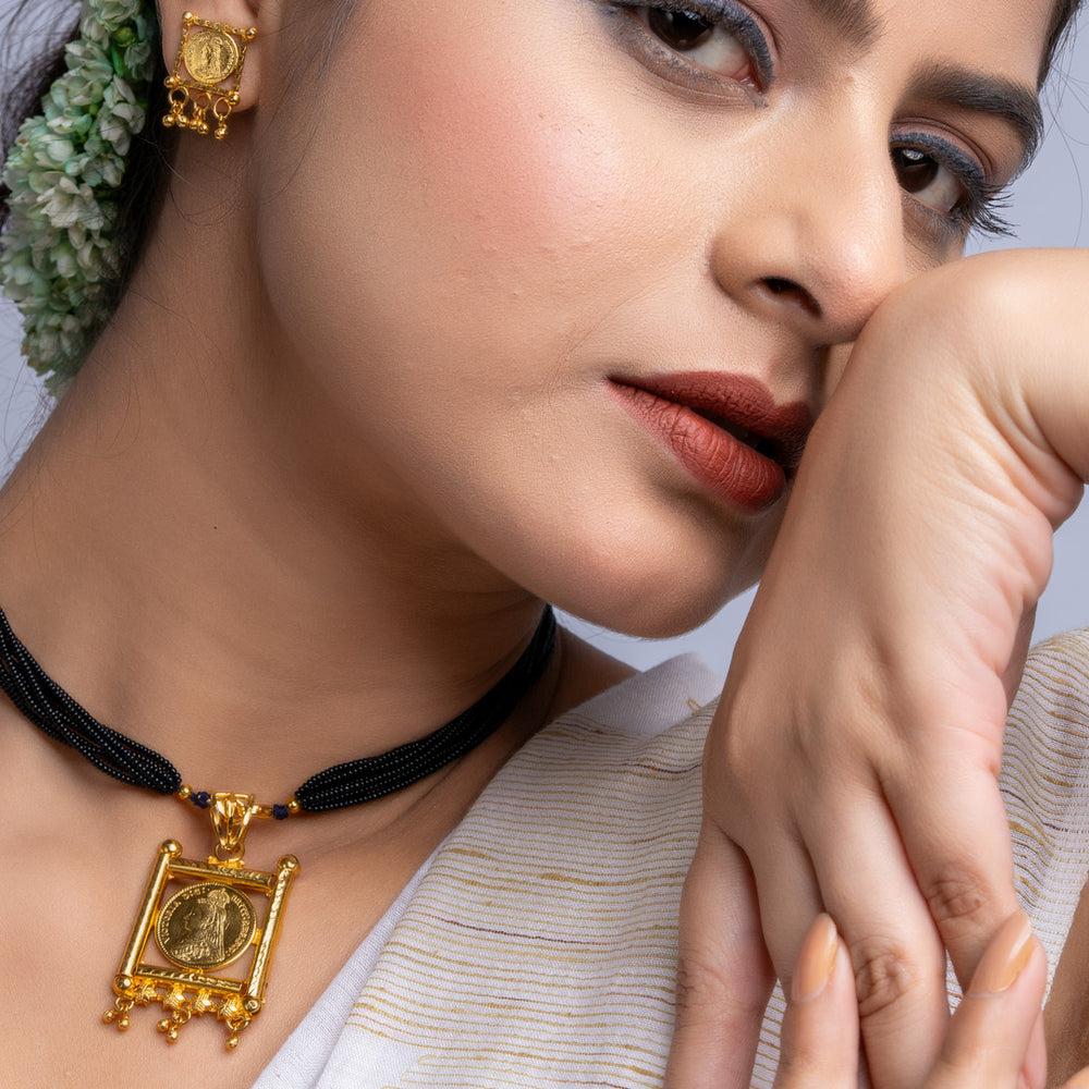 LOOK AND ADORN gold plated necklace set with traditional pendant and matching earrings worn by woman