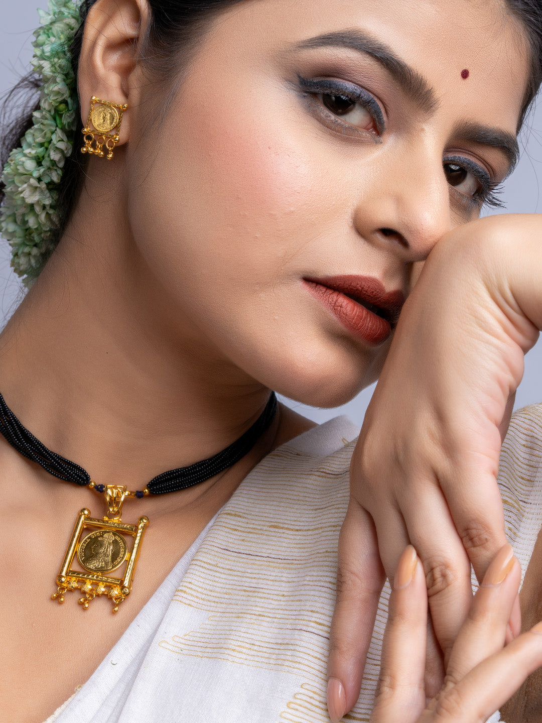LOOK AND ADORN gold plated necklace set with traditional pendant and matching earrings worn by woman