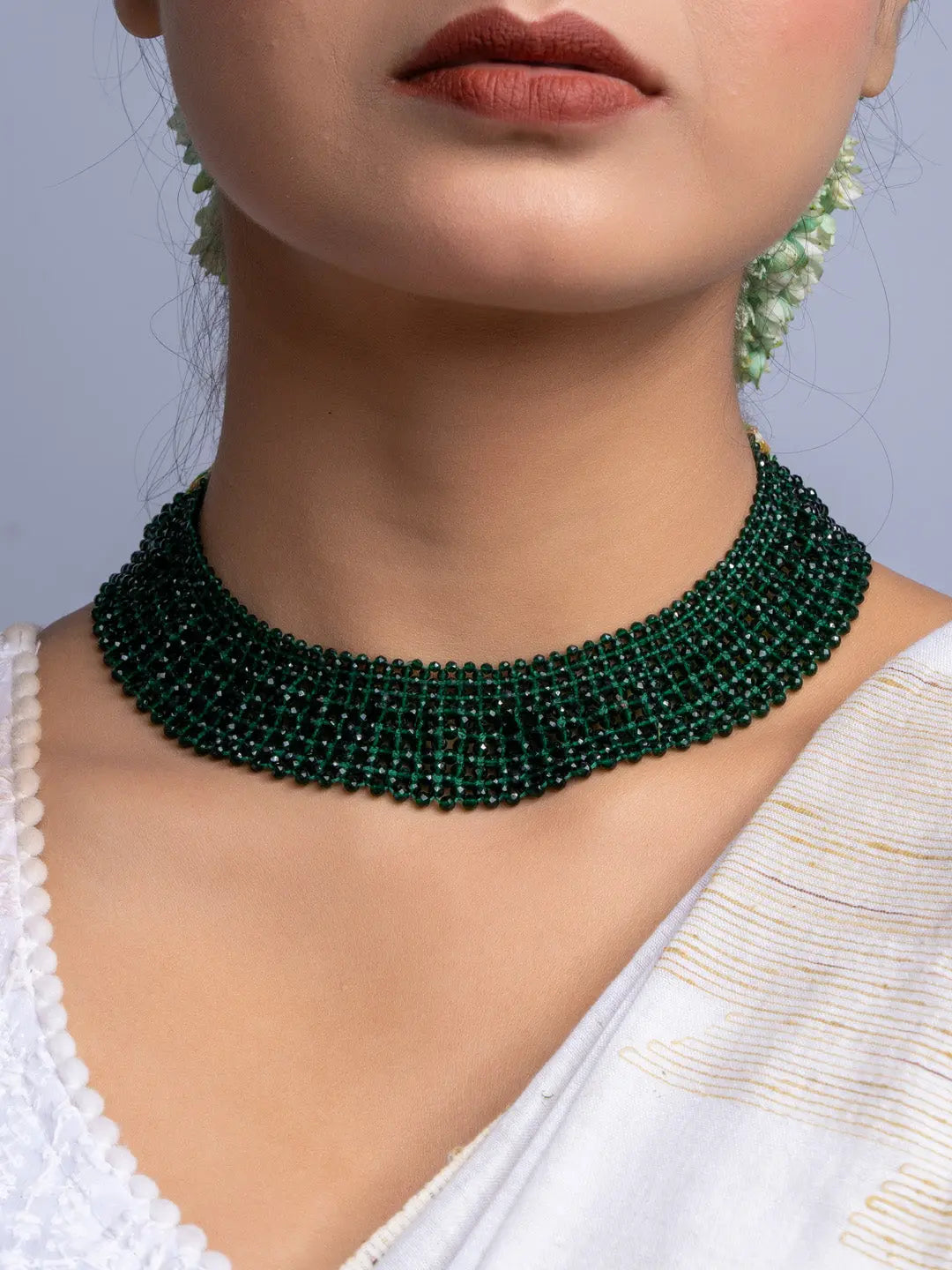 Handmade green crystal necklace by LOOK AND ADORN worn on neck with white traditional attire