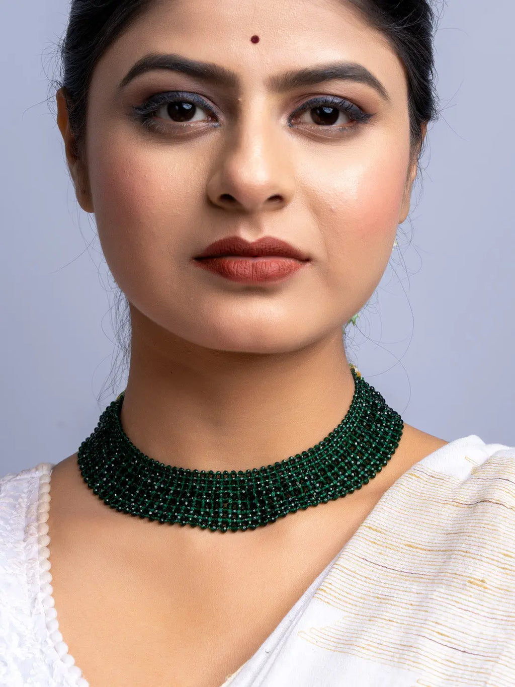 Woman wearing a handmade green crystal necklace by LOOK AND ADORN designed for you