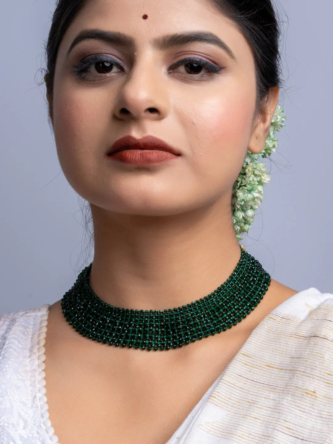 Handmade green crystal necklace by LOOK AND ADORN worn on woman with traditional attire
