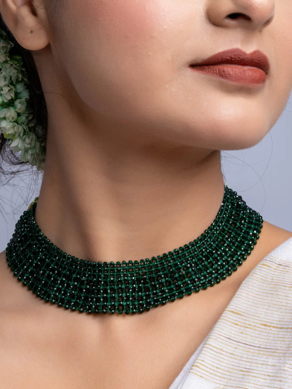 Handmade green crystal necklace with multiple strands worn around the neck by a woman
