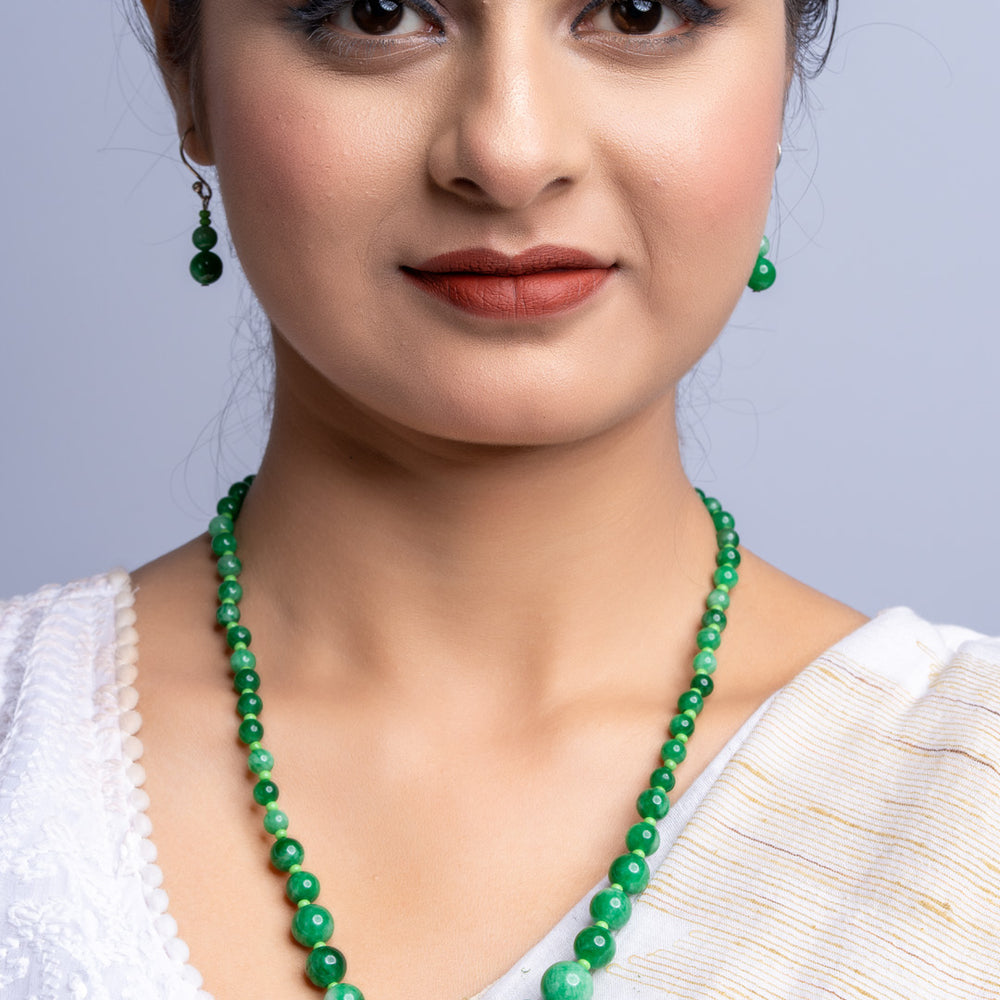 LOOK AND ADORN handmade green onyx necklace worn with matching earrings and white traditional outfit