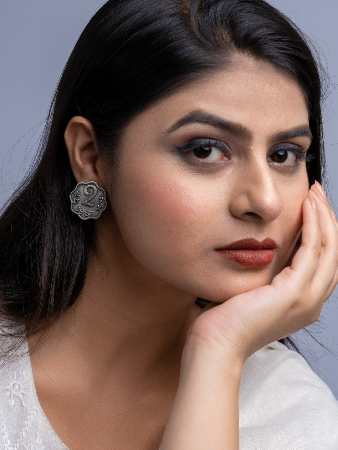 Close-up of woman wearing oxidised silver earrings with intricate floral design by LOOK AND ADORN