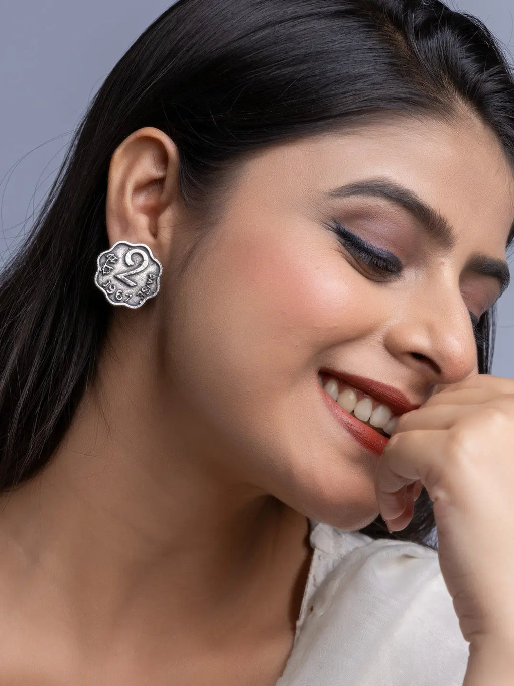 Close up of woman wearing oxidised silver earrings with intricate floral design by LOOK AND ADORN