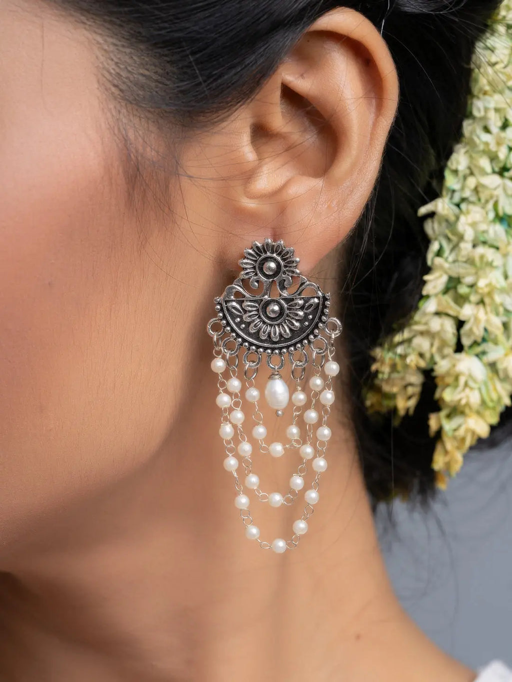 Handmade pearl stud earrings with intricate silver floral design and cascading pearl strands