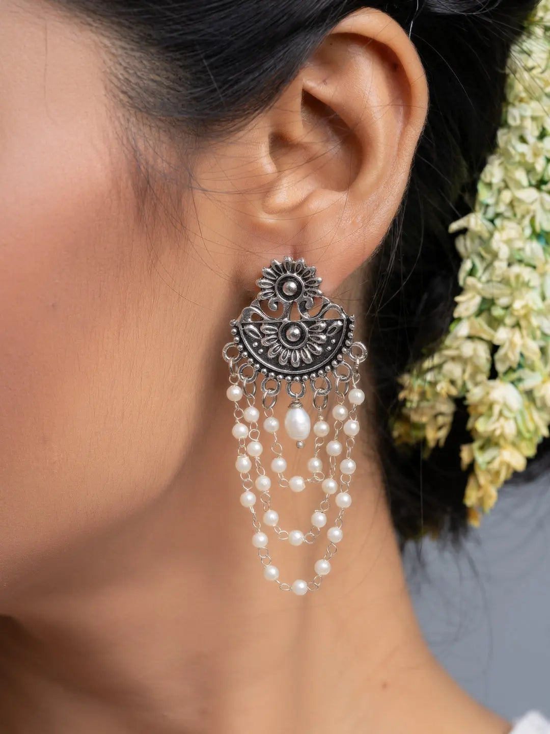 Handmade pearl stud earrings with intricate silver floral design and cascading pearl strands