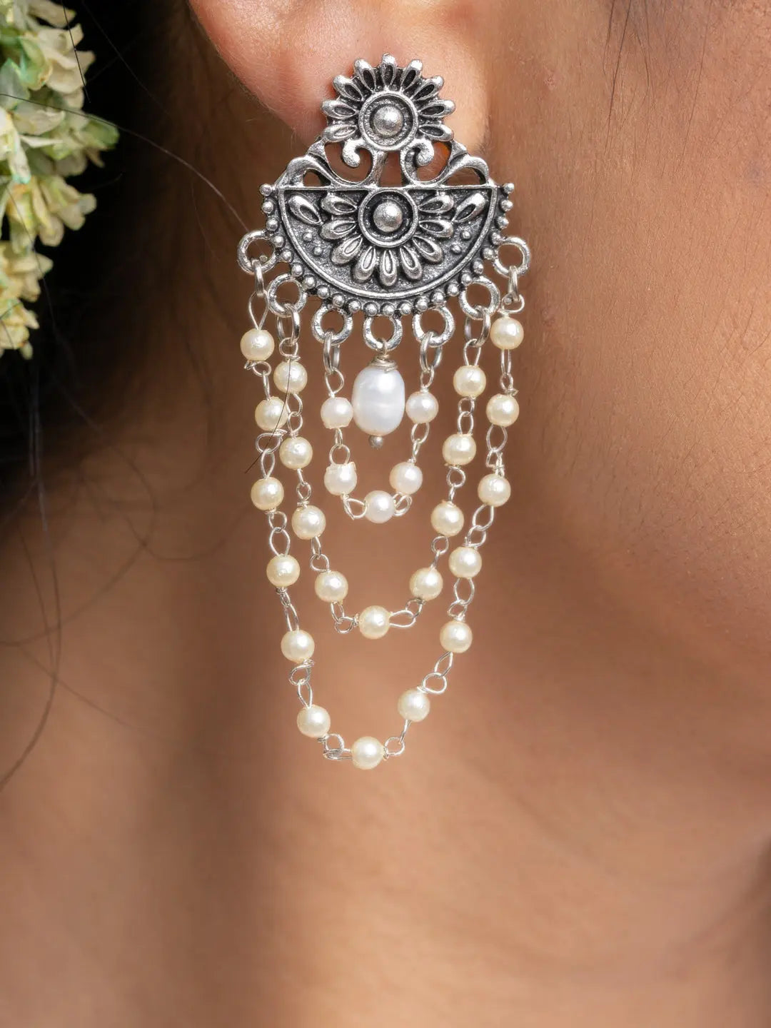 Handmade pearl stud earrings with intricate silver design and dangling pearl chains