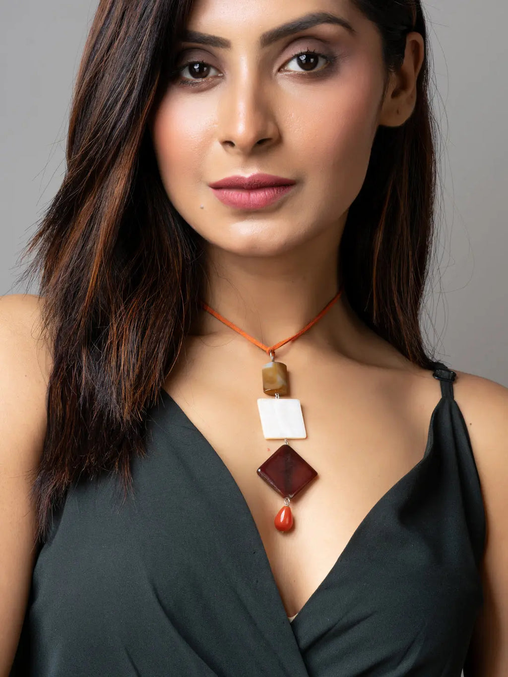 Handmade mother of pearl necklace with geometric stones on woman wearing black top by LOOK AND ADORN