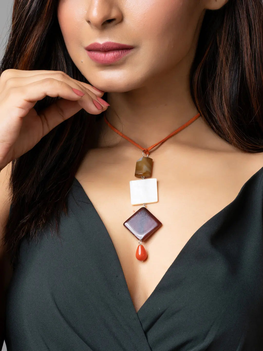 Handmade mother of pearl necklace with geometric stones on a woman wearing a black outfit