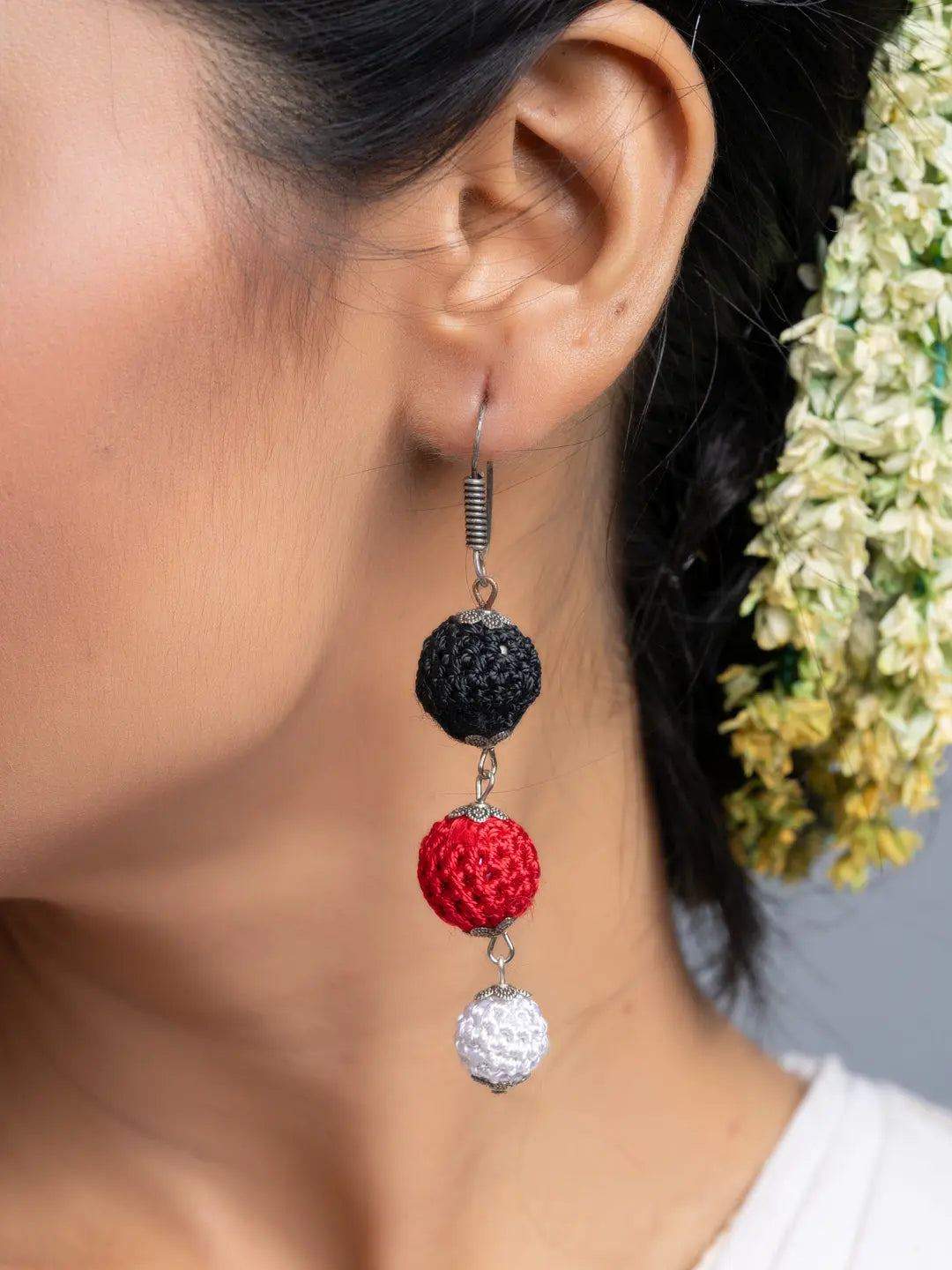 Handmade Black Red Earrings with black, red, and white beads worn on ear by LOOK AND ADORN