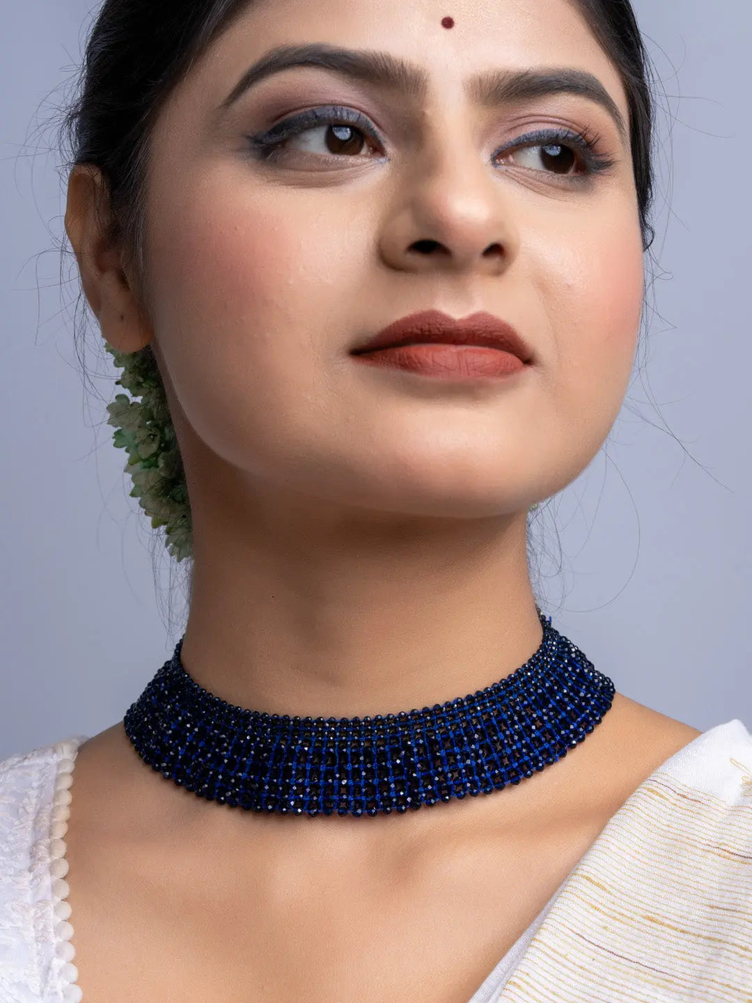Handmade blue crystal necklace by LOOK AND ADORN worn on model's neck with elegant design