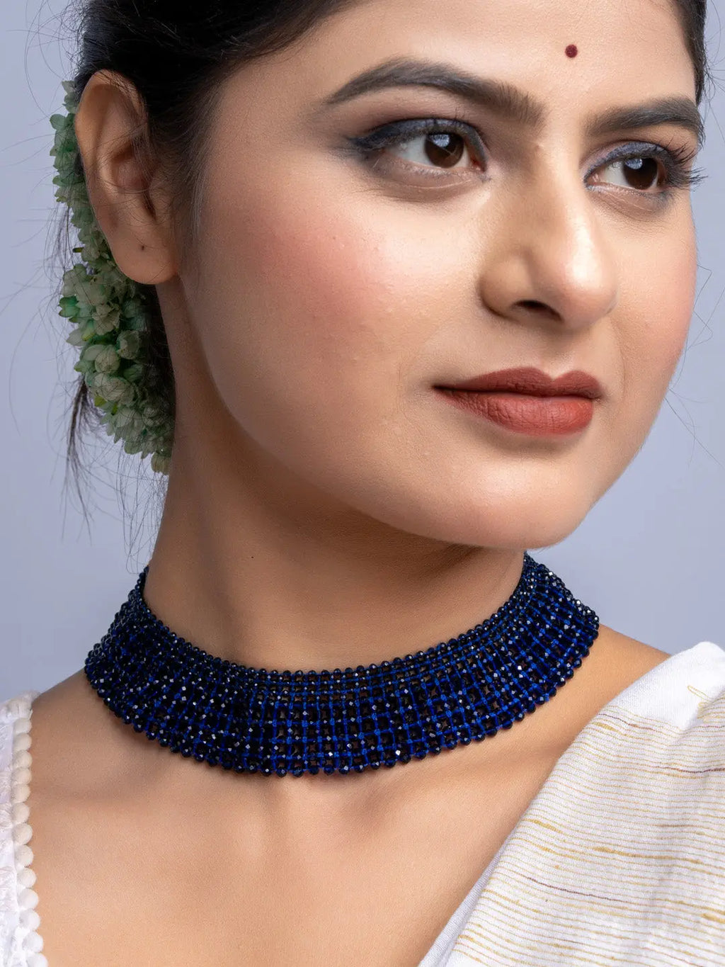 Handmade blue crystal necklace by LOOK AND ADORN worn on a woman with elegant makeup and traditional hairstyle