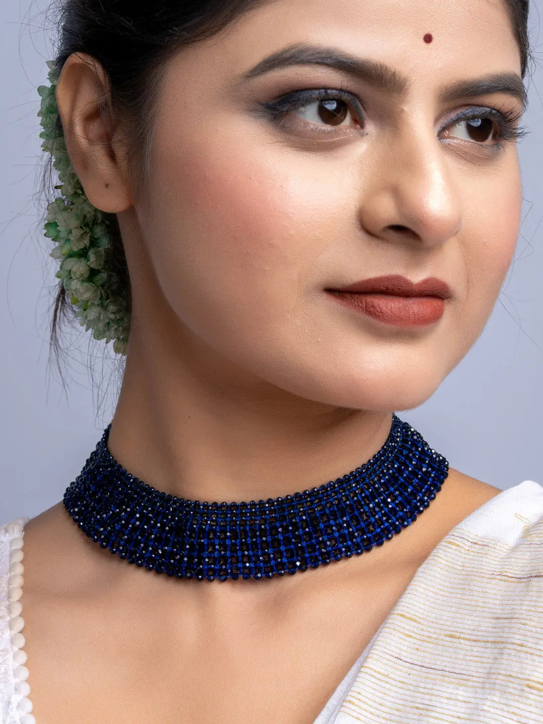 Handmade blue crystal necklace by LOOK AND ADORN worn on a woman with elegant makeup and traditional hairstyle