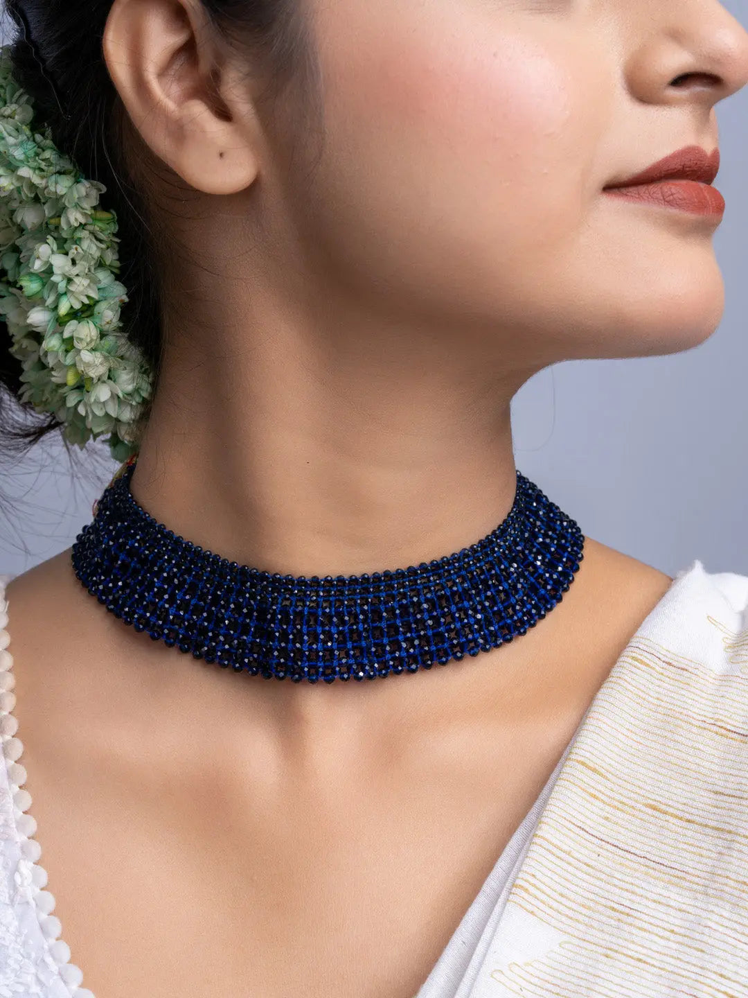 Handmade blue crystal necklace by LOOK AND ADORN worn on neck with traditional attire