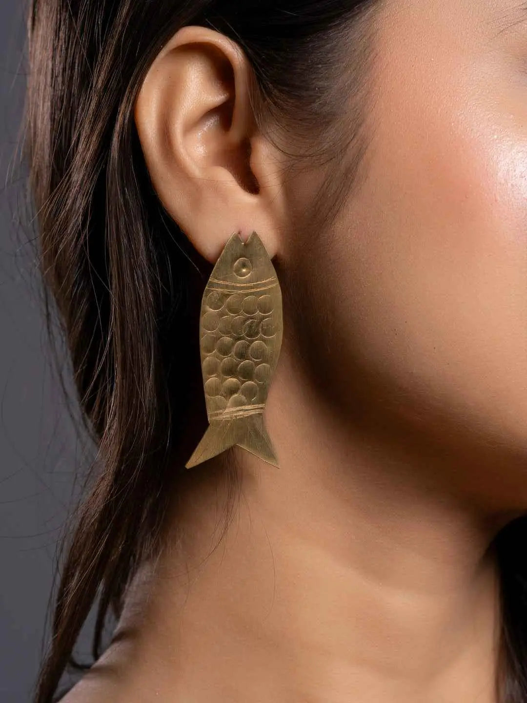 Brass earrings in fish shape with textured scales for a unique and stylish accessory