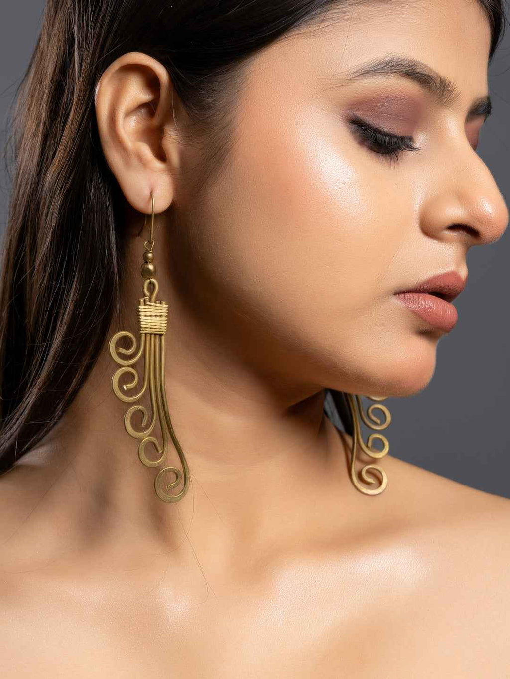 Brass earrings in an elegant swirling design, crafted from Dokra jewellery by LOOK AND ADORN