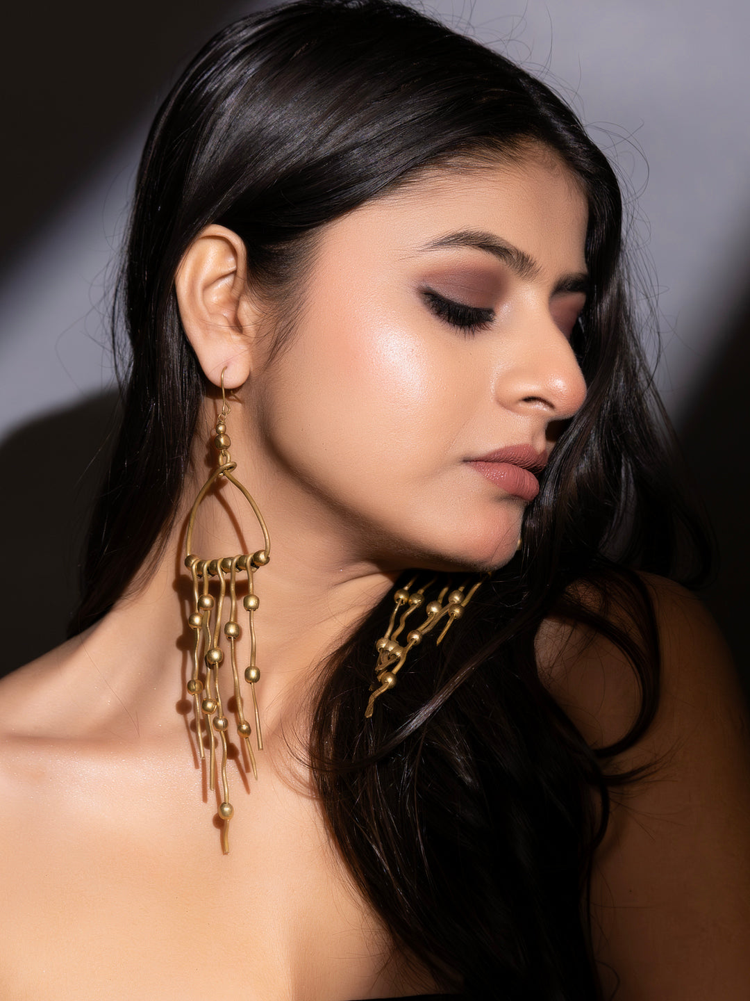 Dokra brass earrings with intricate design and dangling beads, perfect for a stylish look