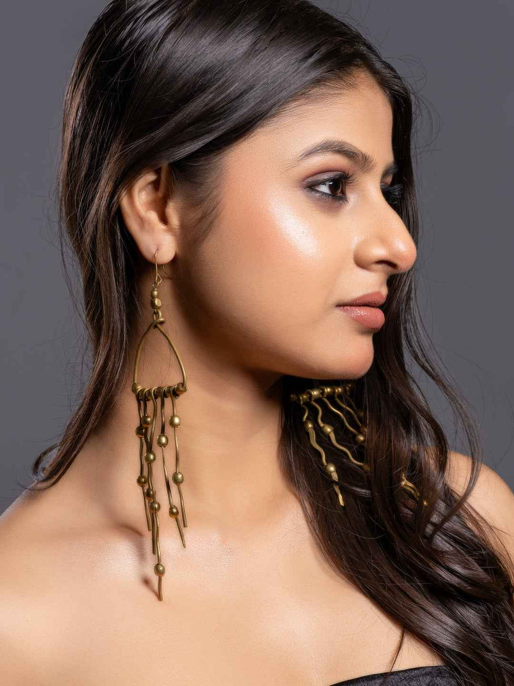 Stylish Dokra brass earrings in antique gold with detailed dangles for a bohemian look