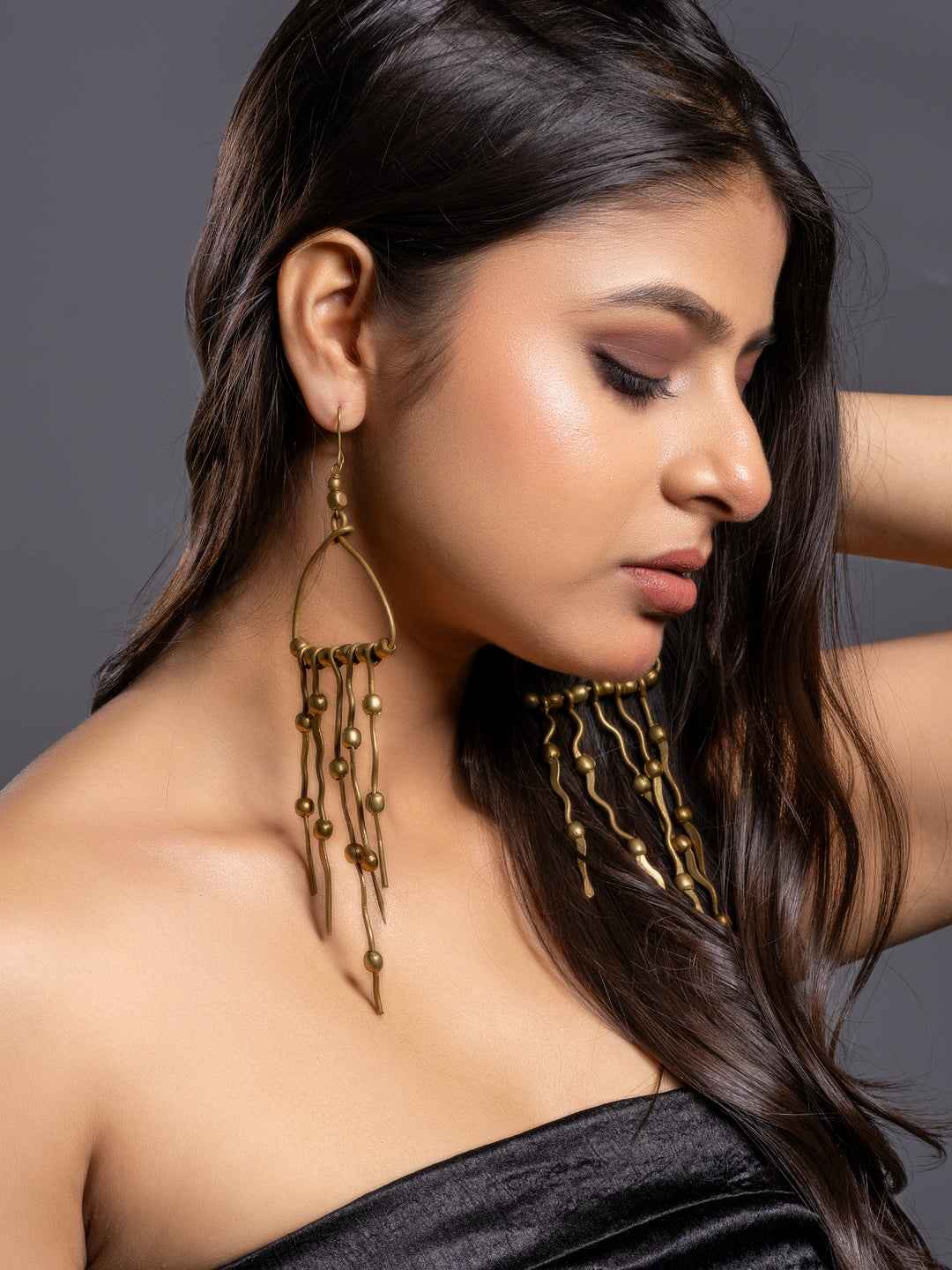 Brass earrings with dangling designs featuring textured beads, perfect for a stylish look