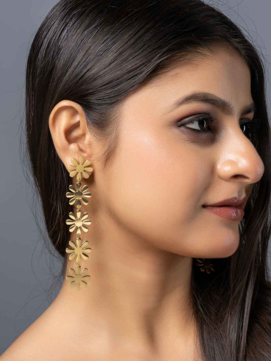 Gold brass stud earrings designed with floral shapes for a trendy, elegant look