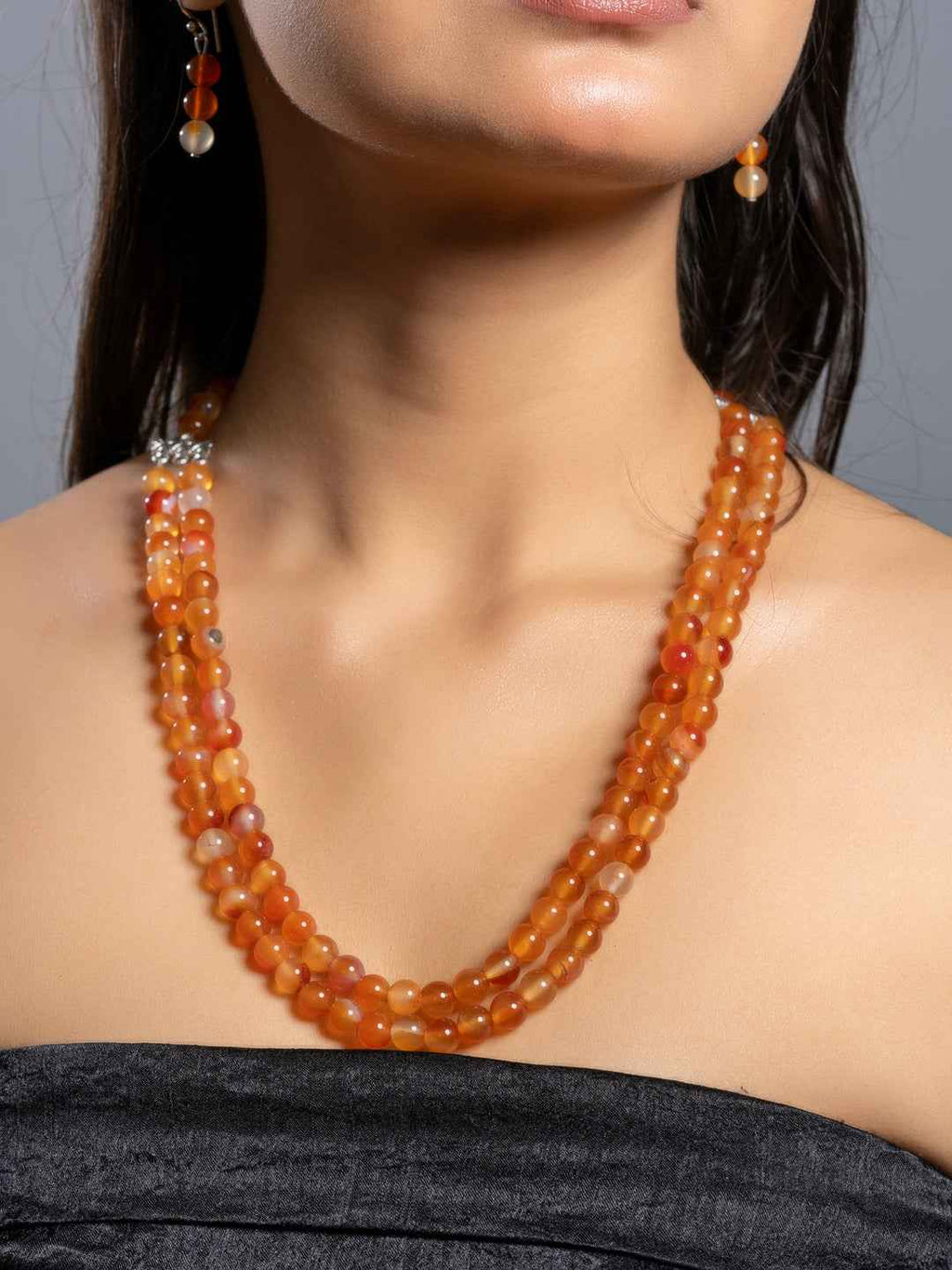 Handmade carnelian necklace set in orange hues with multi-strand design and matching earrings