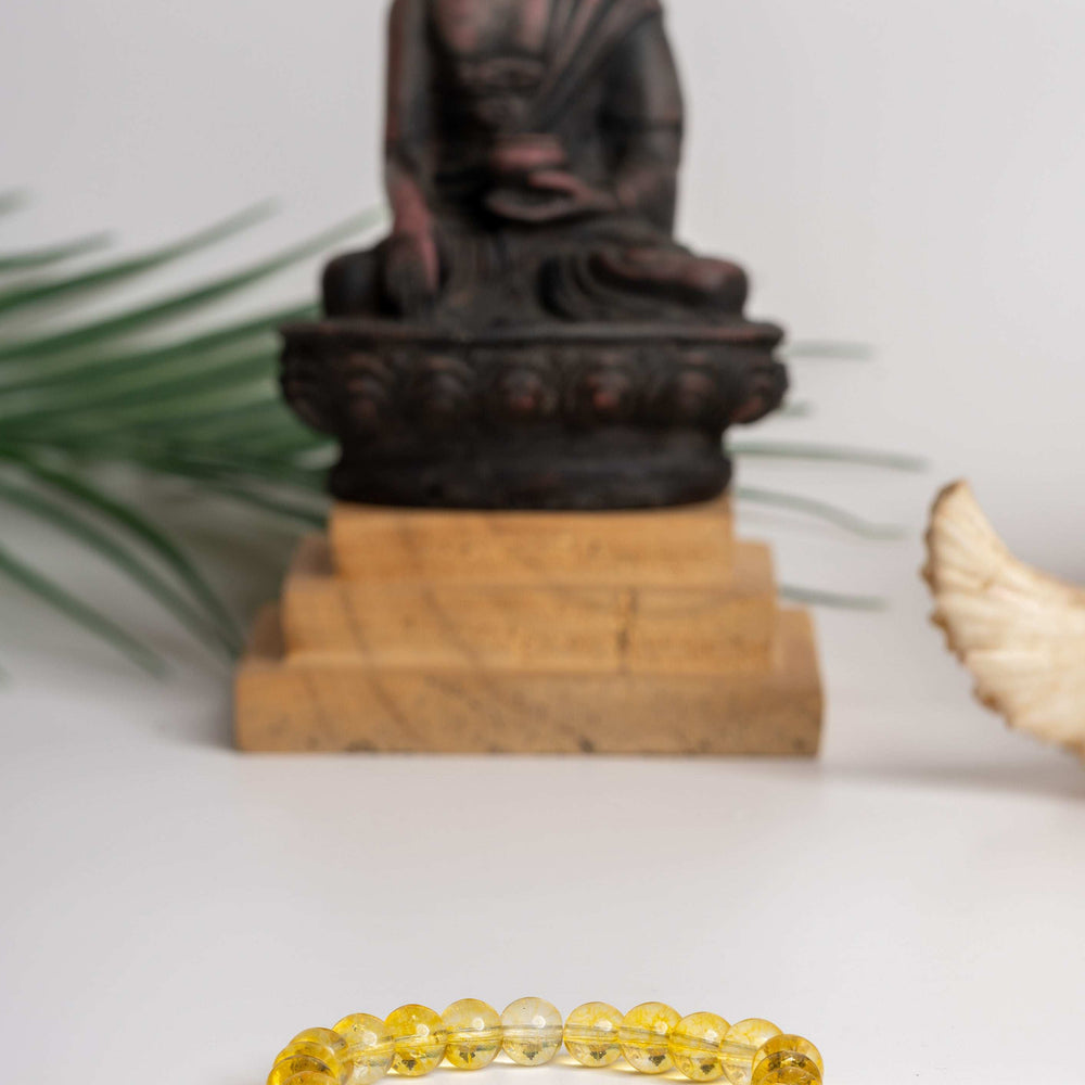Astro-Gemstone Jewellery Yellow Quartz Bracelet by LOOK AND ADORN designed for you, with a Buddha statue backdrop