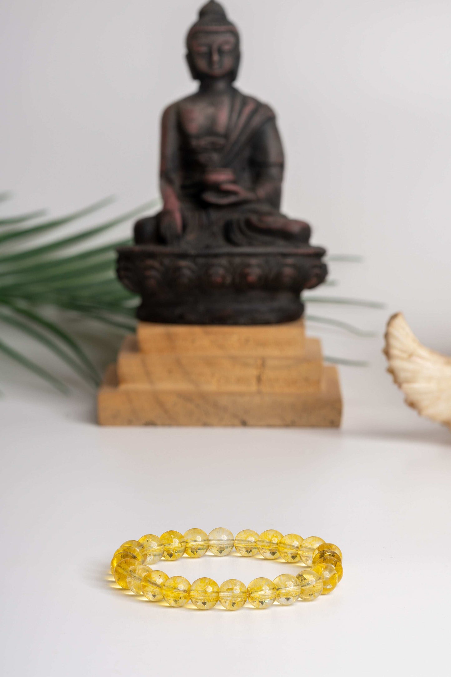 Astro-Gemstone Jewellery Yellow Quartz Bracelet by LOOK AND ADORN designed for you, with a Buddha statue backdrop