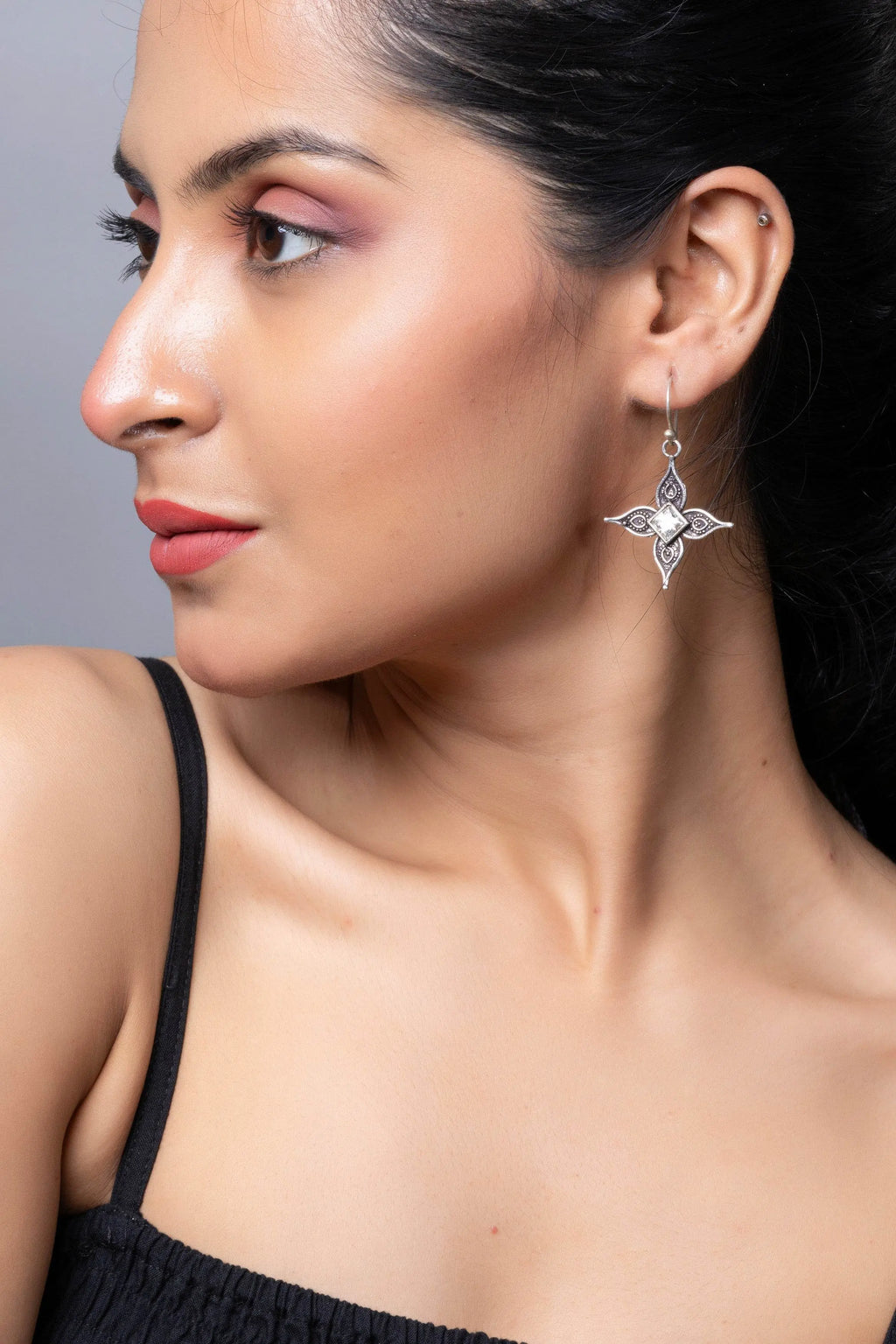 LOOK AND ADORN oxidised silver cubic zirconia earring dangling elegantly on a model