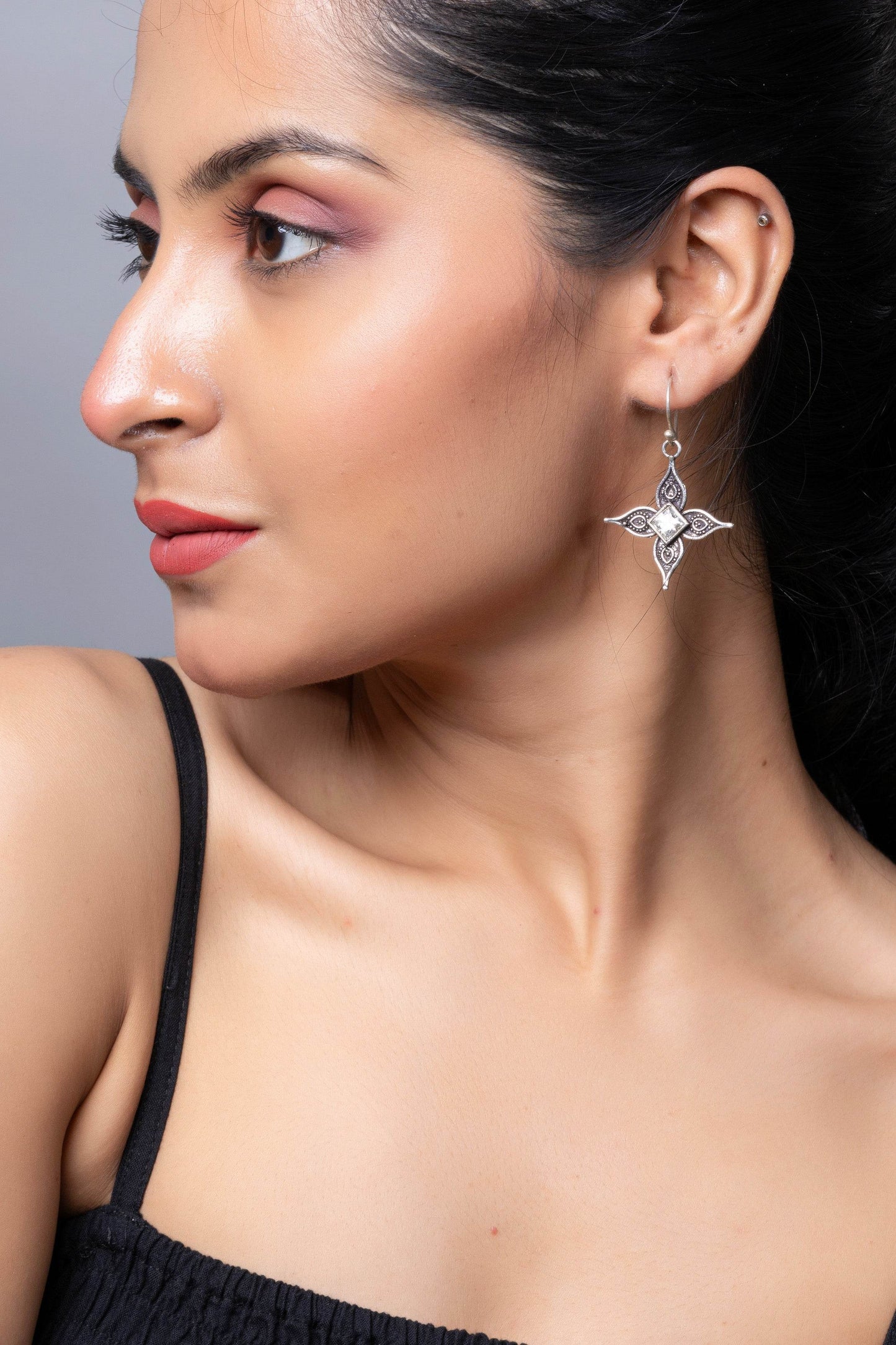 LOOK AND ADORN oxidised silver cubic zirconia earring dangling elegantly on a model