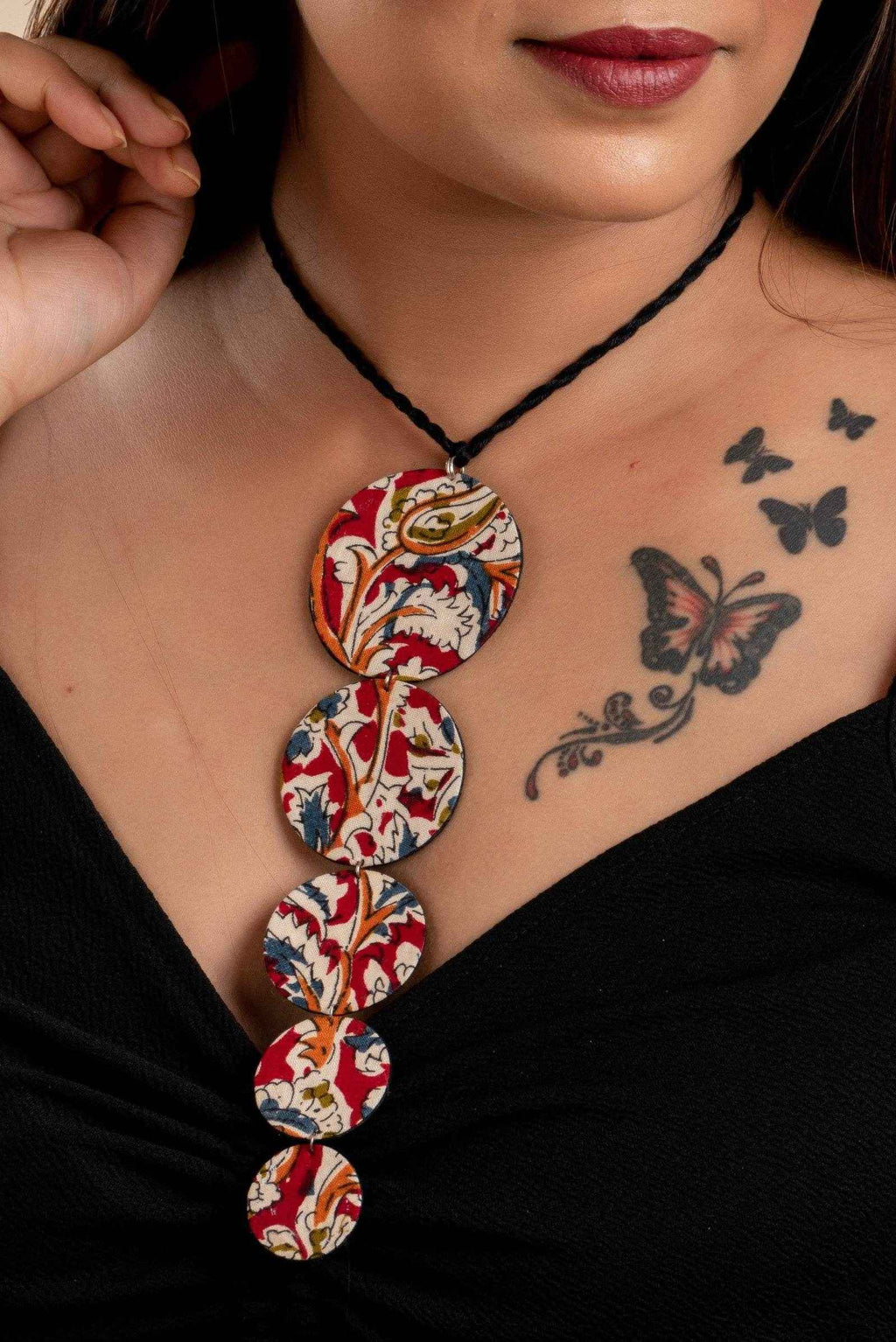 LOOK AND ADORN fabric handmade choker with colorful patterned circular pendants worn on neck