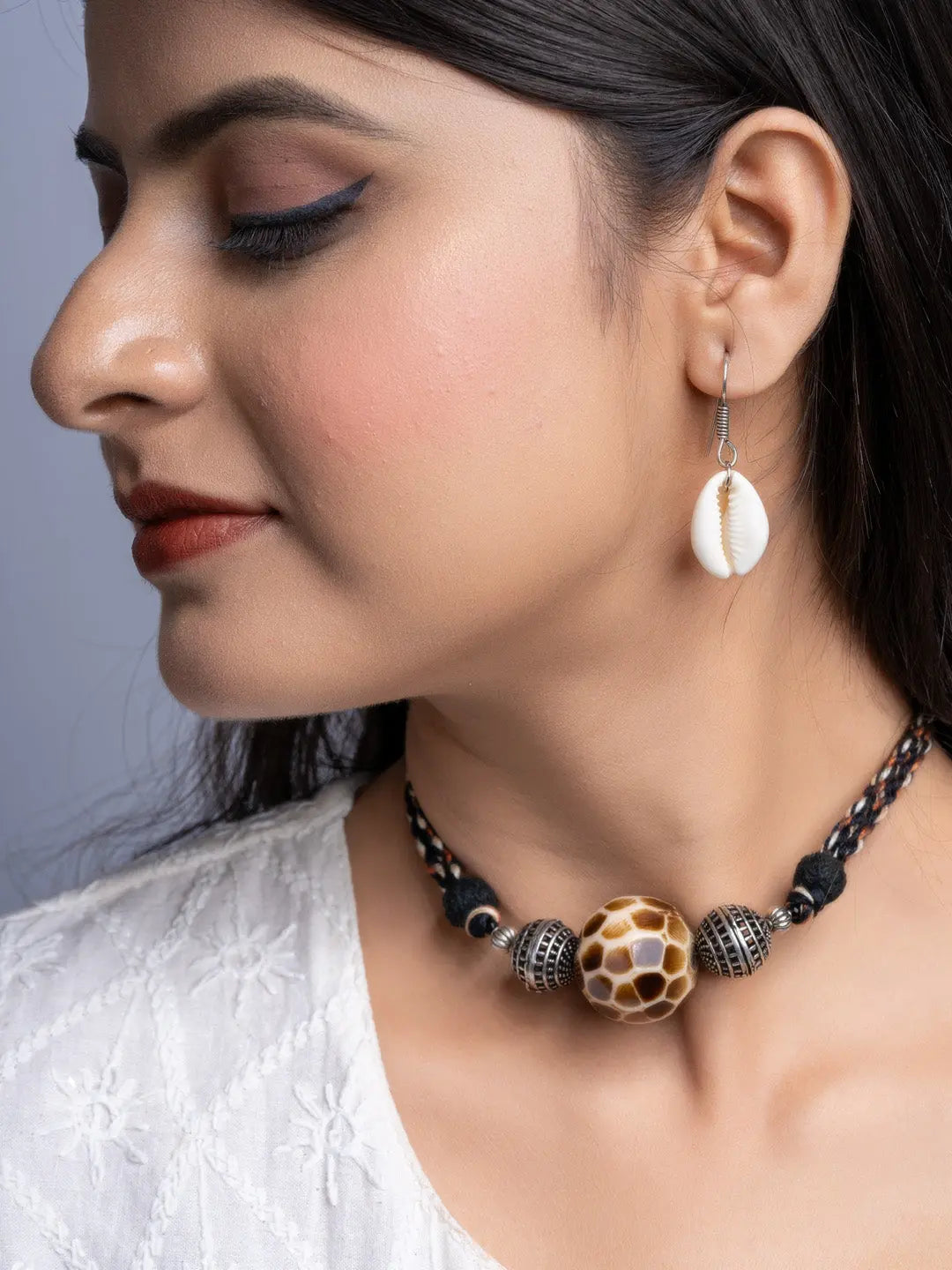 Handmade german silver choker set featuring intricate beads worn by woman with shell earrings