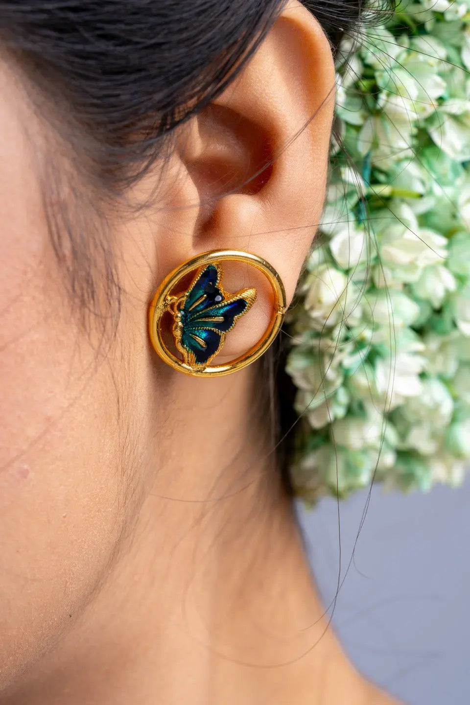 LOOK AND ADORN gold plated earrings with blue and green butterfly design worn on ear
