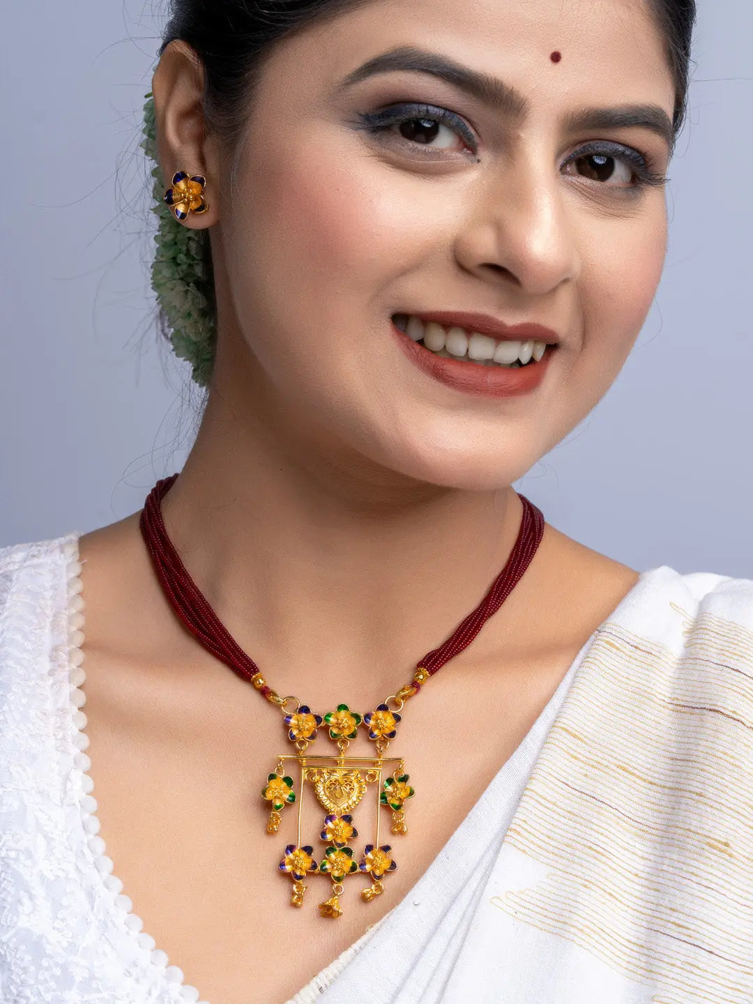 Look and Adorn gold plated traditional necklace and matching earrings on a smiling woman