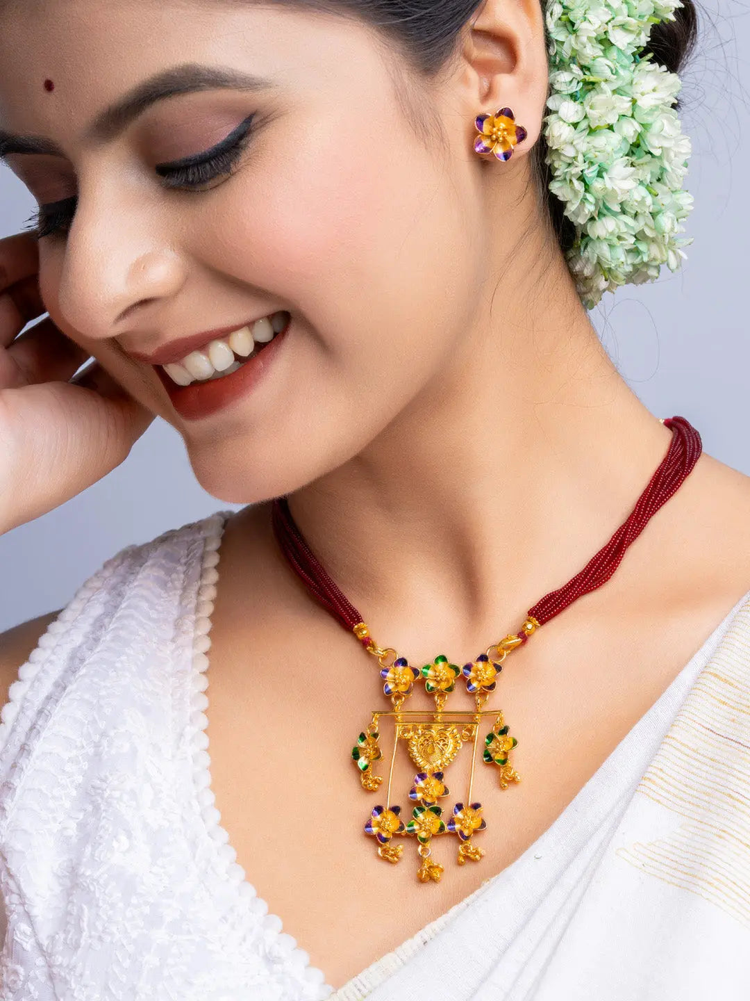 LOOK AND ADORN gold plated floral necklace and earrings set worn by a woman with traditional attire
