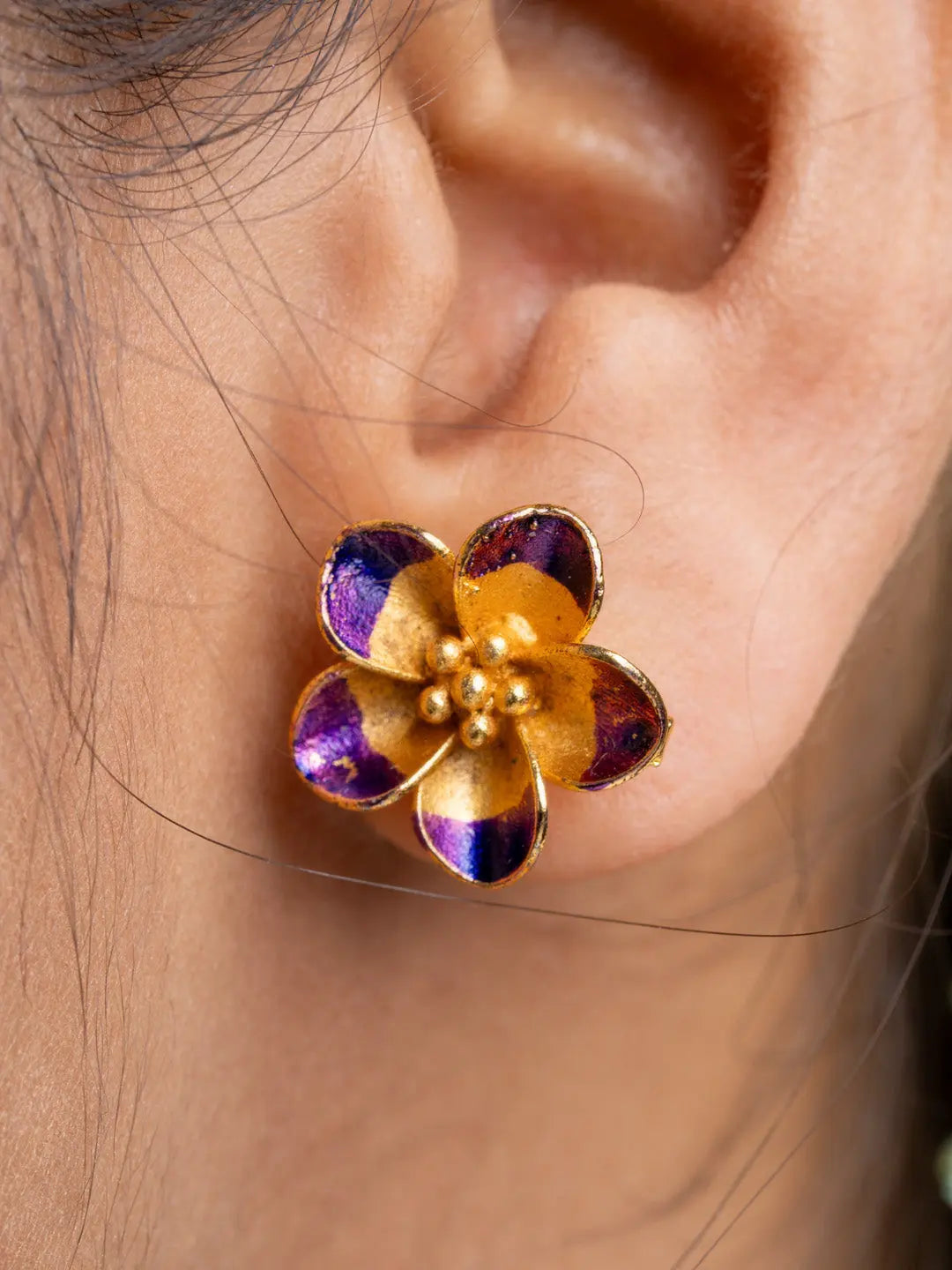 Gold plated flower-shaped stud earring with purple accents from LOOK AND ADORN