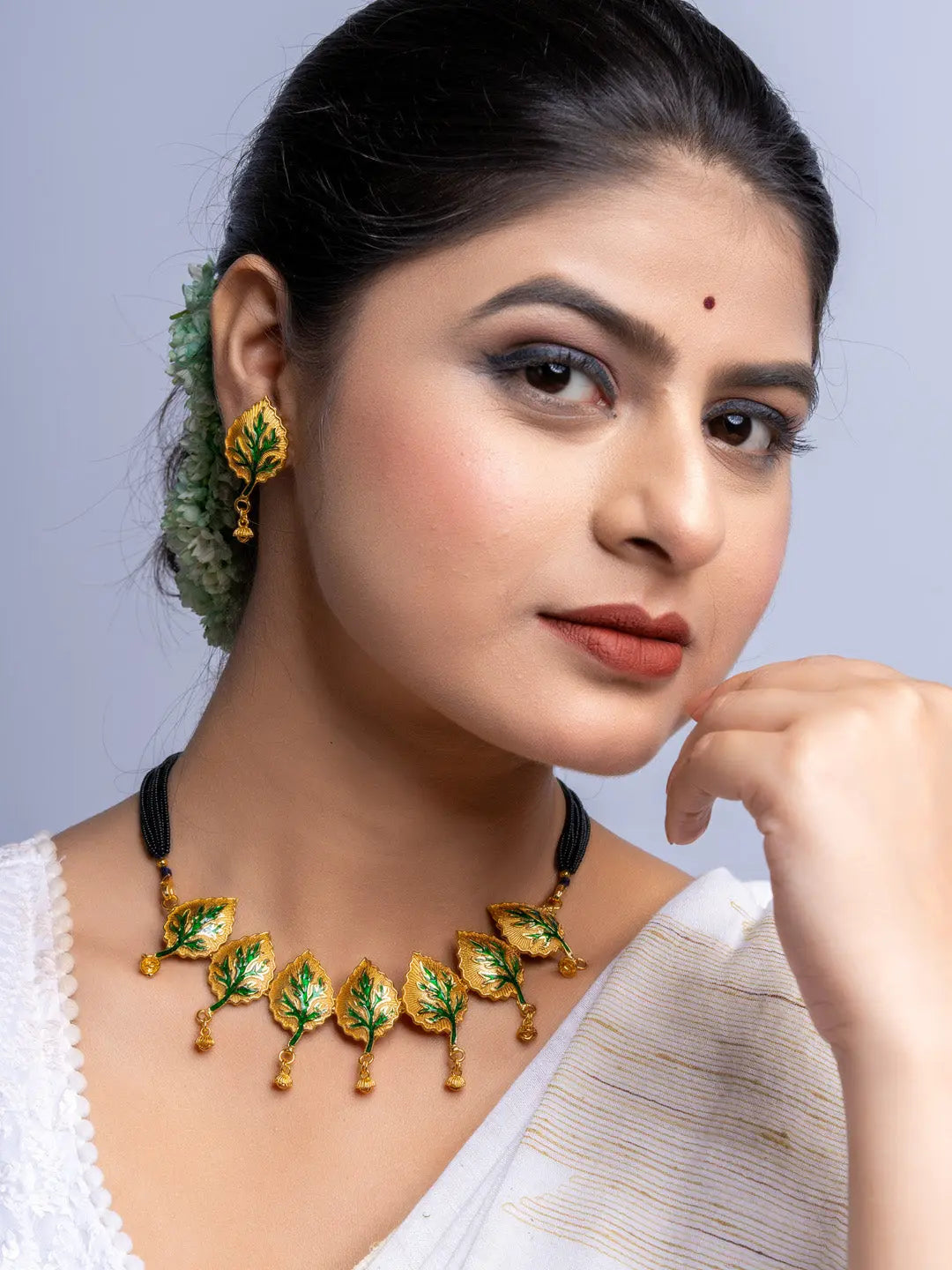 LOOK AND ADORN gold plated leaf design necklace and matching earrings worn by woman