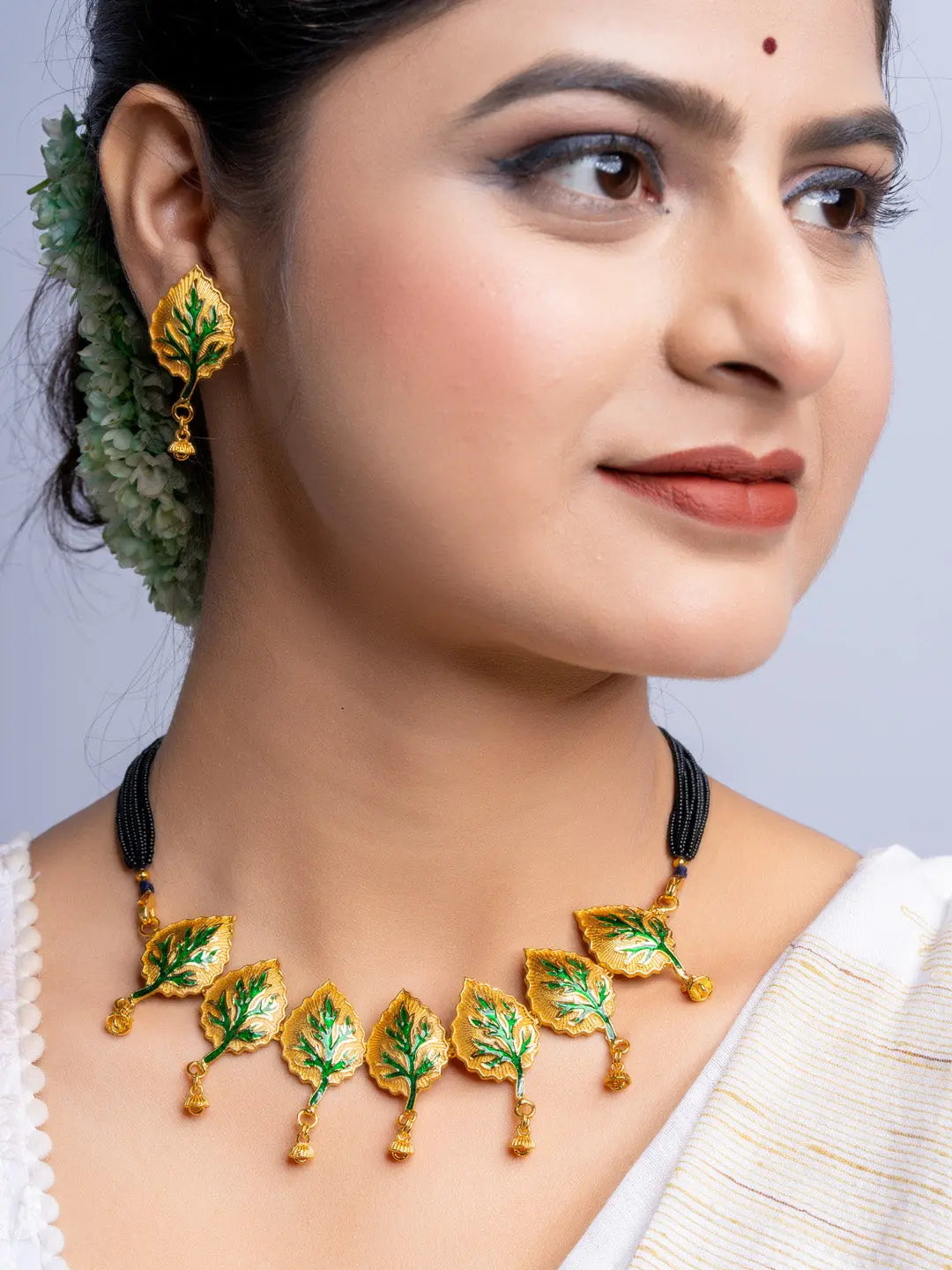 LOOK AND ADORN gold plated leaf design necklace and earrings set on woman with traditional attire