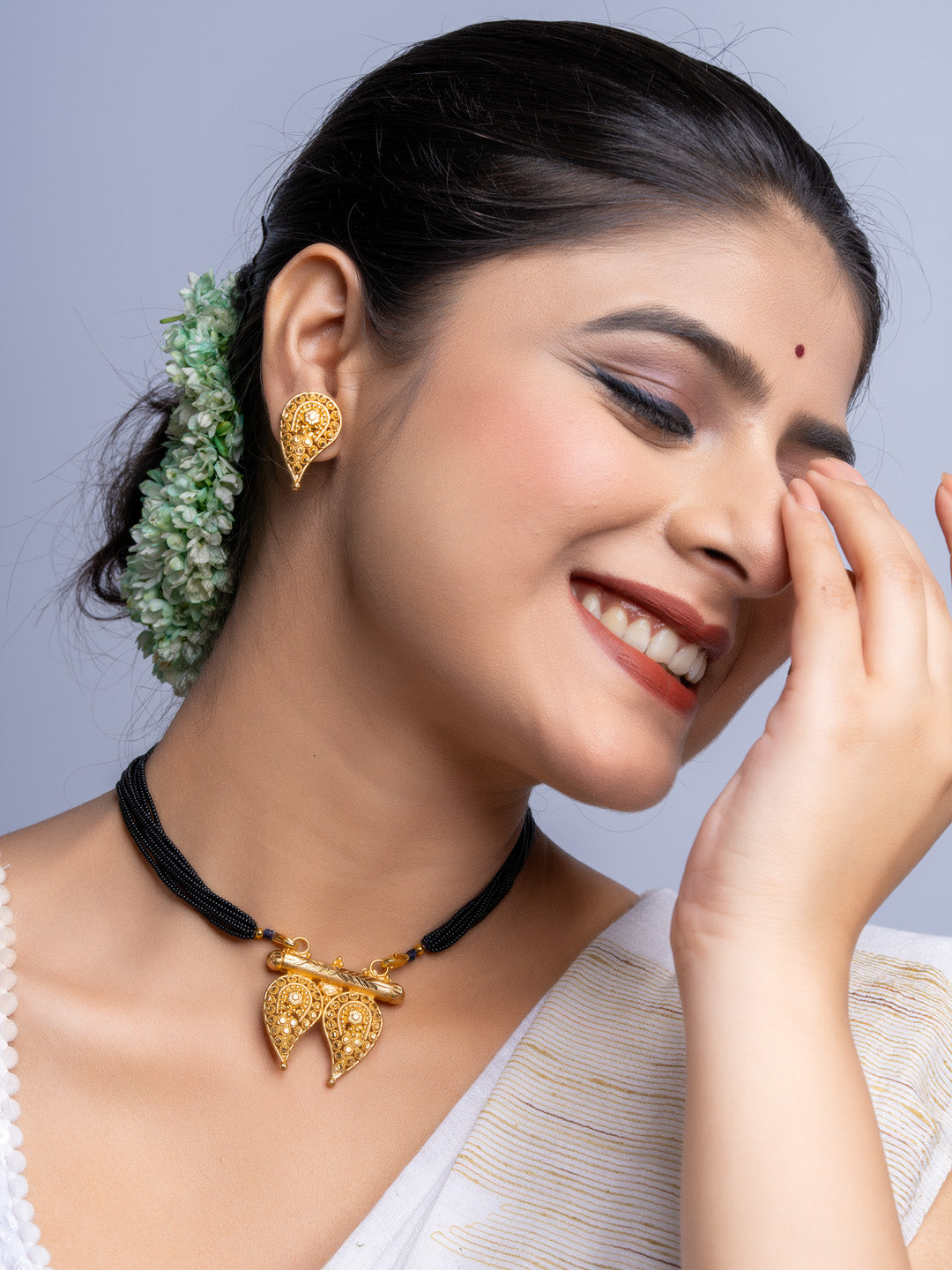 LOOK AND ADORN gold plated intricate necklace and matching earrings worn by smiling woman with traditional hairstyle