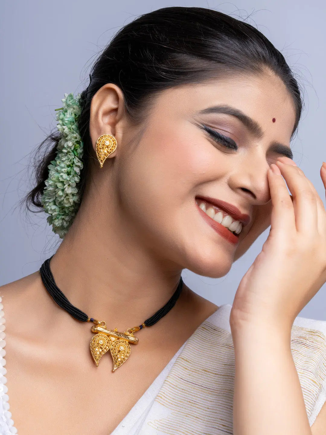LOOK AND ADORN gold plated intricate necklace and matching earrings worn by smiling woman with traditional hairstyle