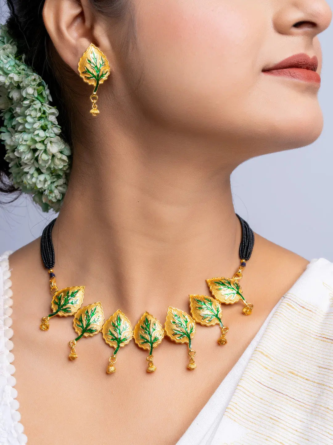 LOOK AND ADORN gold plated leaf design necklace and matching earrings set on model