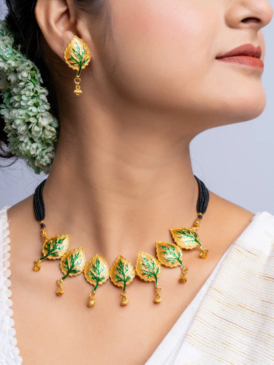 LOOK AND ADORN gold plated leaf design necklace and matching earrings set on model
